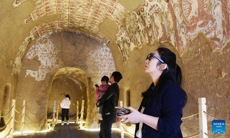 Tourists view murals in the Ya'er Lake Grottoes in the city of Turpan, northwest China's Xinjiang Uygur Autonomous Region, April 5, 2025. (Photo: Xinhua)