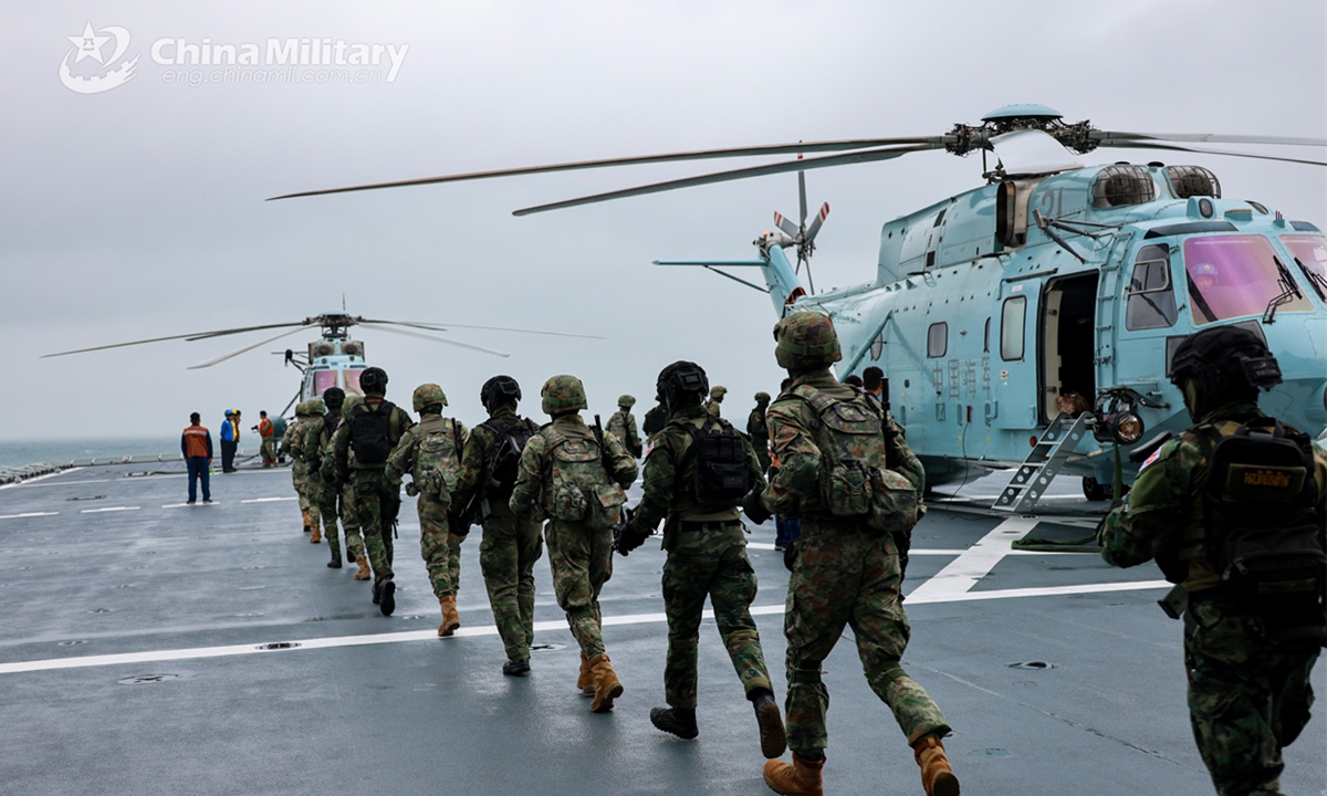 Chinese and Thai participating soldiers rush to board ship-borne helicopters during counterterrorism and anti-piracy operations on March 30, 2025. China-Thailand Blue Strike 2025 joint naval training was held in south China's Guangdong Province from March 26 to April 2, 2025. During the joint training, both sides' participating troops conducted joint underwater mine countermeasure operation, anti-ship strike, maritime search and rescue, and field survival operation, as well as other training subjects both in the sea and land domains. (eng.chinamil.com.cn/Photo)