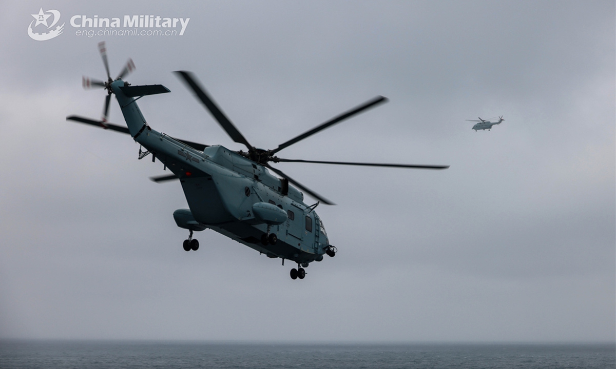 Ship-borne helicopters lift off from the flight deck of the amphibious dock landing ship Qilianshan (Hull 985) to the designated air space on March 30, 2025. China-Thailand Blue Strike 2025 joint naval training was held in south China's Guangdong Province from March 26 to April 2, 2025. During the joint training, both sides' participating troops conducted joint underwater mine countermeasure operation, anti-ship strike, maritime search and rescue, and field survival operation, as well as other training subjects both in the sea and land domains. (eng.chinamil.com.cn/Photo)