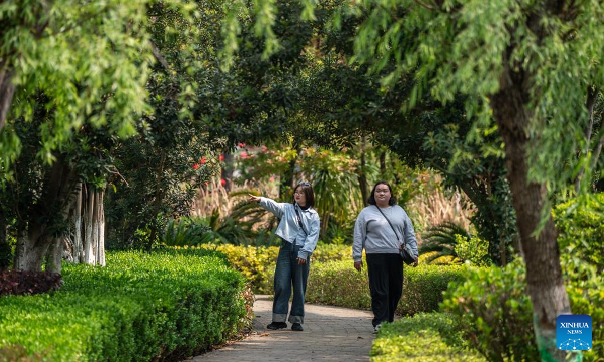 Tourists visit Honghe Nativeland in Mile City, Honghe Hani and Yi Autonomous Prefecture, southwest China's Yunnan Province, April 6, 2025. During this year's three-day Qingming Festival holiday, citizens and tourists came to this city's Huquan Ecological Park, Dongfengyun Town, Honghe Nativeland and other places to enjoy the spring scenery.   (Photo: Xinhua)