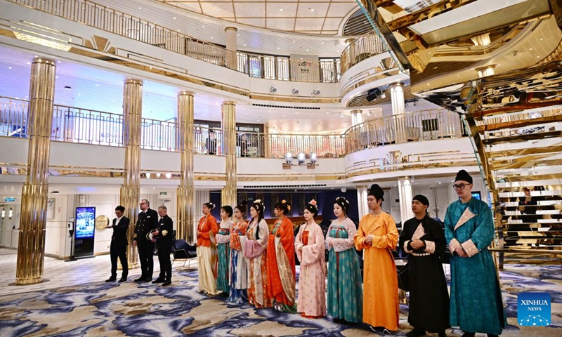Crew members of Adora Magic City greet the passengers on board at the Qingdao International Cruise Terminal in Qingdao, east China's Shandong Province, April 6, 2025. As China's first domestically built large cruise ship, Adora Magic City embarked on its commercial maiden voyage on Jan. 1, 2024. This time, the cruise ship made its debut in Qingdao, which is its first appearance in a Chinese port city other than its home port in Shanghai, and will depart for Jeju of South Korea and Fukuoka of Japan. Photo: Xinhua