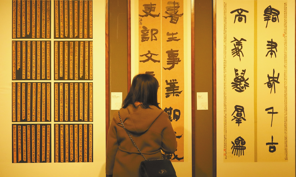 A tourist appreciates one of exhibits at the Gansu Jiandu Museum. Photo: VCG 