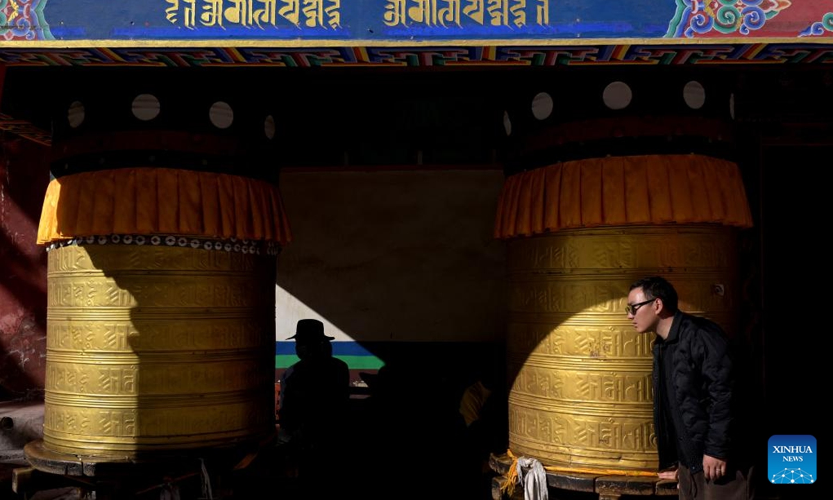 People pray as they circle the Jiana mani stone mound in Yushu City, Yushu Tibetan Autonomous Prefecture, northwest China's Qinghai Province, April 6, 2025. The Jiana mani stone mound is a cultural relic under national protection. The mound is composed of billions of mani stones and used by local people when they hold prayers' wheels and mutter the six-syllable prayer to observe their daily ritual.  (Xinhua/Zheng Huansong)
