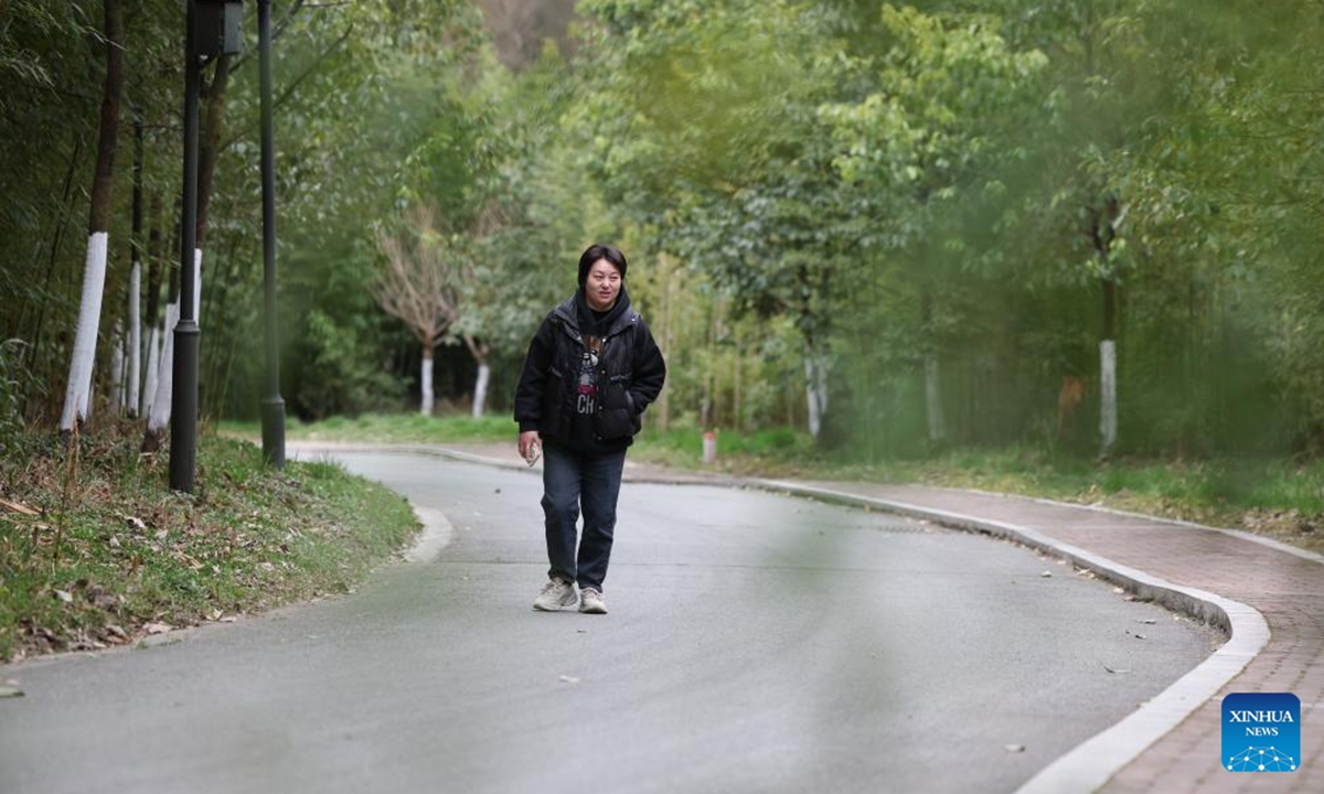 Giant panda keeper Li Rong walks on her way to work at the Shenshuping giant panda base of Wolong National Nature Reserve in southwest China's Sichuan Province, March 28, 2025.（Photo: Xinhua）