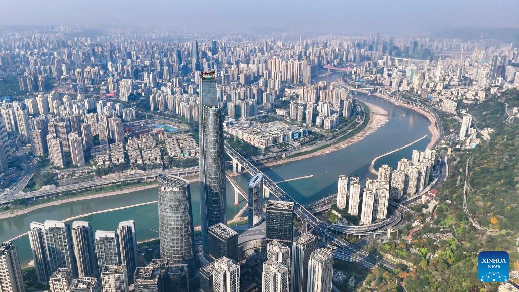 An aerial drone photo taken on April 9, 2025 shows a view of the international land-sea center and its surrounding area in southwest China's Chongqing Municipality. The construction of facade curtain wall of the international land-sea center, the tallest building under construction in Chongqing, was officially completed on Wednesday. Located in Yuzhong District, the 458-meter-high skyscraper has a curtain wall area of about 100,000 square meters, and more than 18,000 glass plates are used. (Photo: Xinhua)