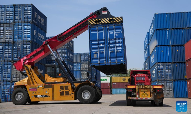 A crane loads containers at a logistics company in Beilun District of Ningbo City, east China's Zhejiang Province, April 10, 2025. In recent years, Beilun District has tailored its development plans for key industrial chains, continuously enhancing the level of digital transformation among enterprises in the region, aiming to develop a number of advantageous industrial clusters and leading enterprises. In 2024, the total output value of industrial enterprises above designated size in Beilun District achieved 585.727 billion yuan (about 80.1 billion U.S. dollars), marking a year on year increase of 9.6 percent. (Photo: Xinhua)