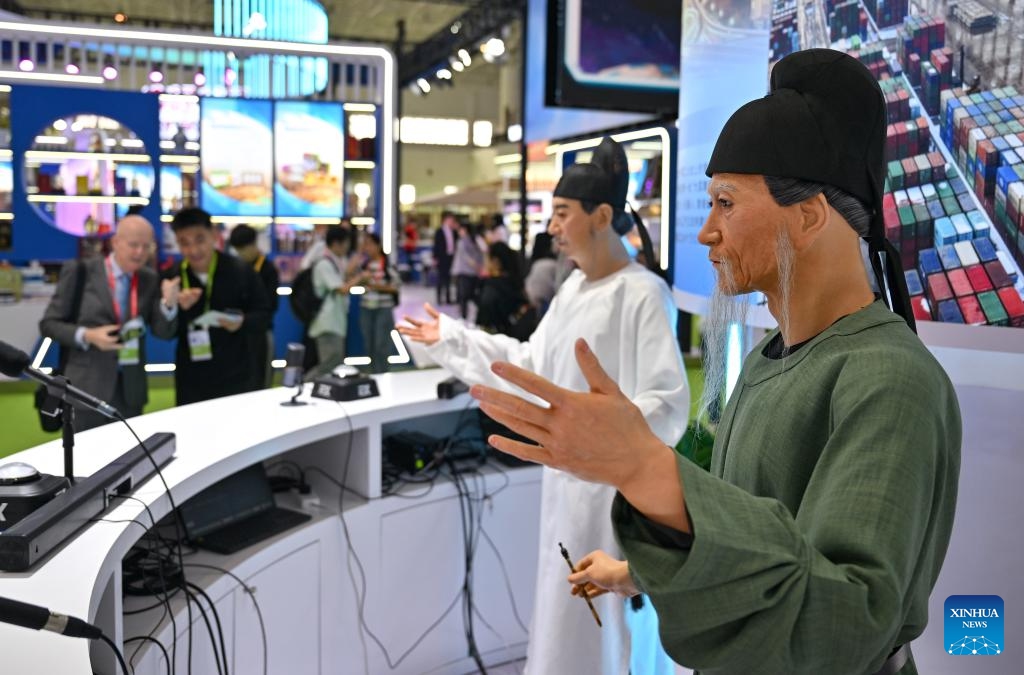 Two humanoid robots wearing traditional costumes are pictured at the 5th China International Consumer Products Expo (CICPE) in Haikou, south China's Hainan Province, April 13, 2025. This year's expo highlights future technology through the debut of various cutting-edge robots. By showcasing AI-powered functionalities and real-world applications, these robots offer a glimpse into the future of daily life. (Photo: Xinhua)