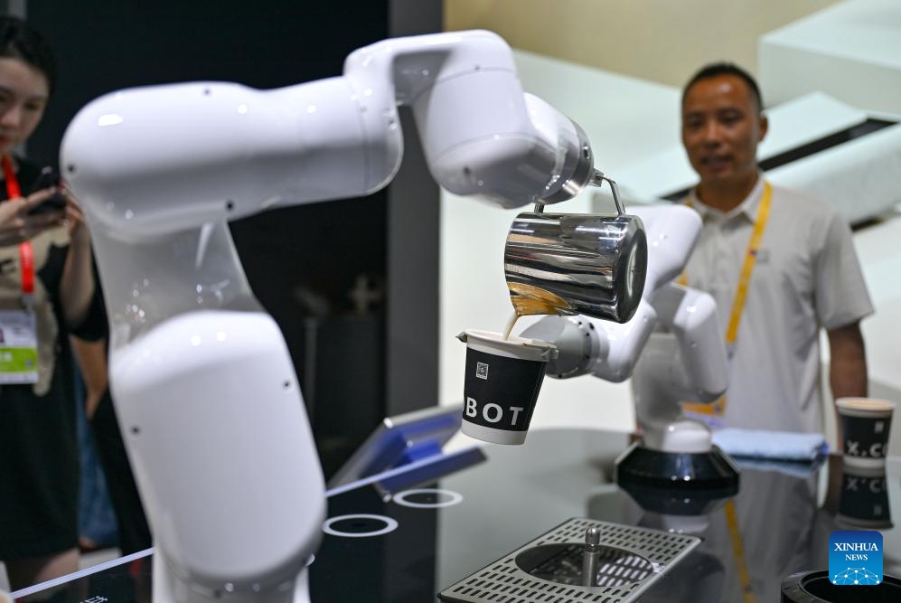 A robot makes latte art at the 5th China International Consumer Products Expo (CICPE) in Haikou, south China's Hainan Province, April 13, 2025. This year's expo highlights future technology through the debut of various cutting-edge robots. By showcasing AI-powered functionalities and real-world applications, these robots offer a glimpse into the future of daily life. (Photo: Xinhua)