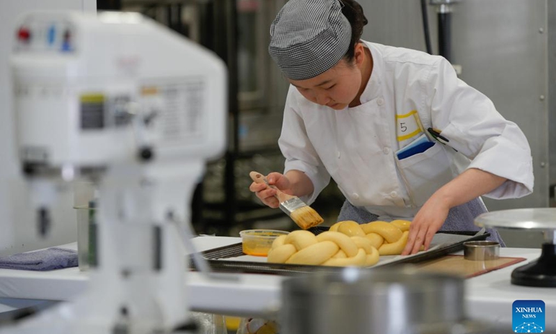 A contestant competes in the Baking category during the 2025 Provincial Trade and Technology Competition in Abbotsford, British Columbia, Canada, on April 16, 2025. Over 600 secondary and post-secondary students competed here Wednesday in trade and technology contests, including carpentry, plumbing, electrical, baking, welding, graphic design, 3D animation, robotics, and more. (Photo: Xinhua)