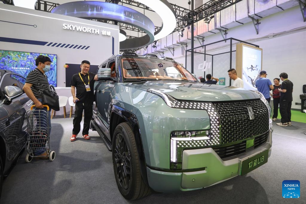 Visitors look at a new energy vehicle at the 5th China International Consumer Products Expo (CICPE) in Haikou, south China's Hainan Province, April 16, 2025. From intangible cultural heritage skills to technological trendy products, Chinese brands showcased its charm at the ongoing CICPE in Haikou, attracting the attention of many visitors. (Photo: Xinhua)