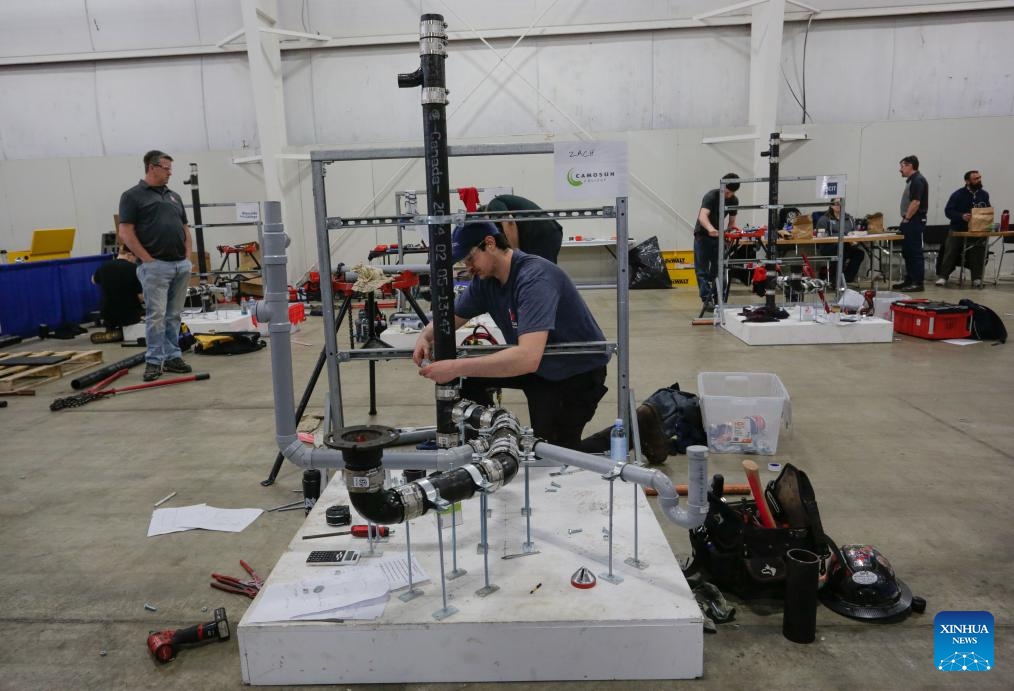 A contestant competes in the Plumbing category during the 2025 Provincial Trade and Technology Competition in Abbotsford, British Columbia, Canada, on April 16, 2025. Over 600 secondary and post-secondary students competed here Wednesday in trade and technology contests, including carpentry, plumbing, electrical, baking, welding, graphic design, 3D animation, robotics, and more. (Photo: Xinhua)