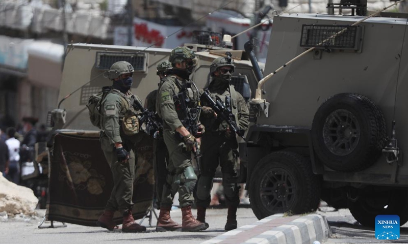 Israeli forces secure the entry as Israeli settlers visit a historical site in the West Bank city of Hebron, during the Jewish Passover holiday on April 16, 2025. (Photo: Xinhua)