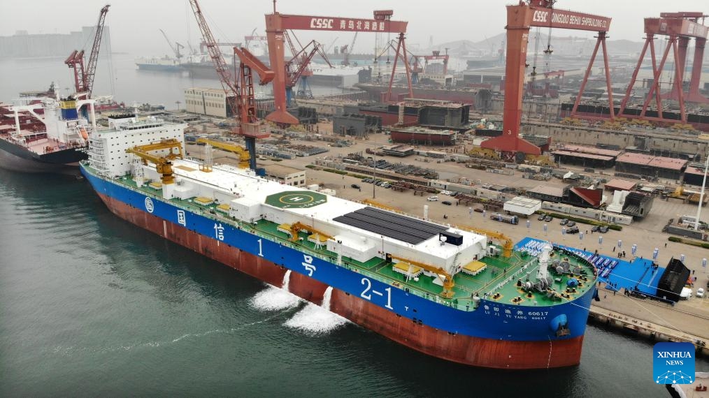An aerial drone photo taken on April 17, 2025 shows a deep-sea intelligent aquaculture vessel berthed at the port of Beihai yard in Qingdao, east China's Shandong Province. A 150,000-tonne deep-sea intelligent aquaculture vessel was delivered for use Thursday in east China's port city of Qingdao. The ship-borne smart aquaculture system is expected to have an annual output of 3,600 tonnes of high-quality fish. The breeding cabins can be used to cultivate fish species such as large yellow croaker and salmon. (Photo: Xinhua)