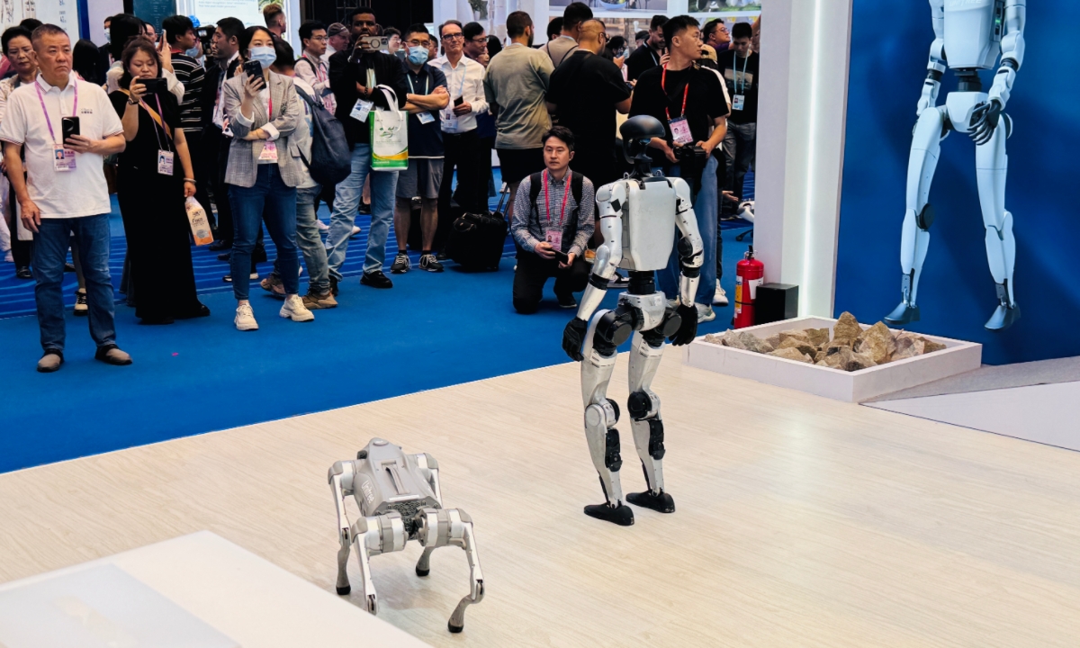 Visitors gather around a Chinese company's booth to watch its humanoid robot and robot dog on display at the 137th Canton Fair in Guangzhou, South China's Guangdong Province, on April 18, 2025. Photo: Chi Jingyi/GT