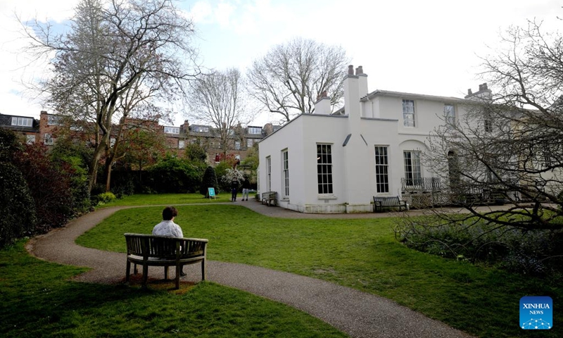 A visitor reads at the garden of Keats House in London, Britain, April 16, 2025. English romantic poet John Keats lived at Keats House from 1818 to 1820, and the house is now a museum dedicated to his life and work. (Photo: Xinhua)