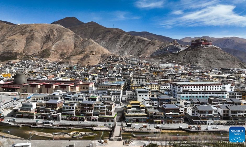 An aerial drone photo taken on April 10, 2025 shows a commercial area in Yushu City of Yushu Tibetan Autonomous Prefecture, northwest China's Qinghai Province. From a bird's eye view, the densely built houses of Yushu City nestle in mountain valleys, while the Batang River meanders through the city like a jade belt. The cityscape of Yushu presents a distinct sense compared to the traditionally perceived cold and arid highland cities. It resembles a city of water with the rich waterways of the Yangtze River source enveloping the main urban area in lush wetlands. (Photo: Xinhua)