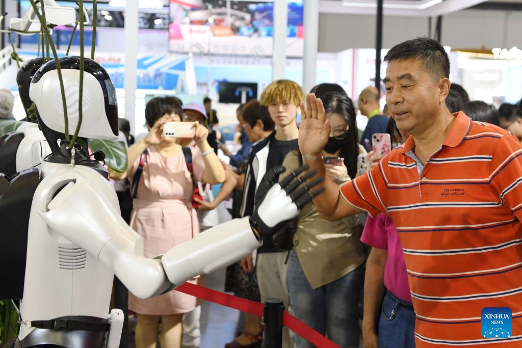 A visitor interacts with a robot at the 5th China International Consumer Products Expo (CICPE) in Haikou, south China's Hainan Province, April 17, 2025. The 5th CICPE opened its door to general public on Thursday, showcasing goods and services across sectors such as technology, healthcare, culture, tourism, and sports. (Photo: Xinhua)