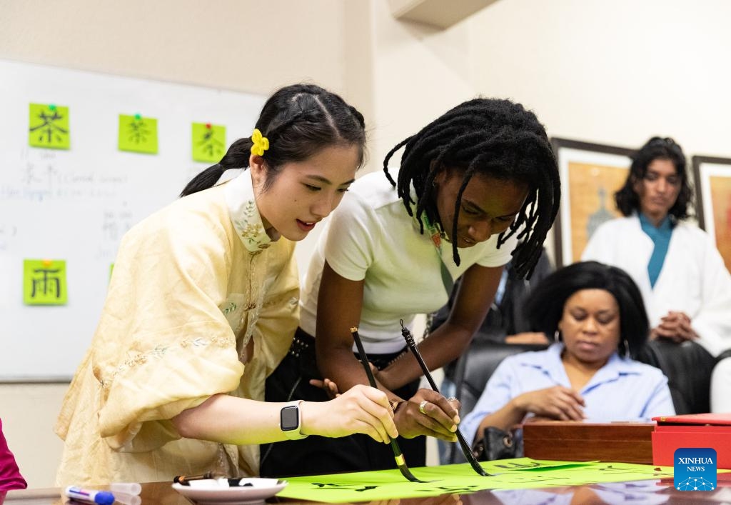 A student and a Confucius Institute volunteer write Chinese calligraphy during an event celebrating the upcoming International Chinese Language Day at the Confucius Institute at the University of Johannesburg in Johannesburg, South Africa, April 17, 2025. (Photo: Xinhua)
