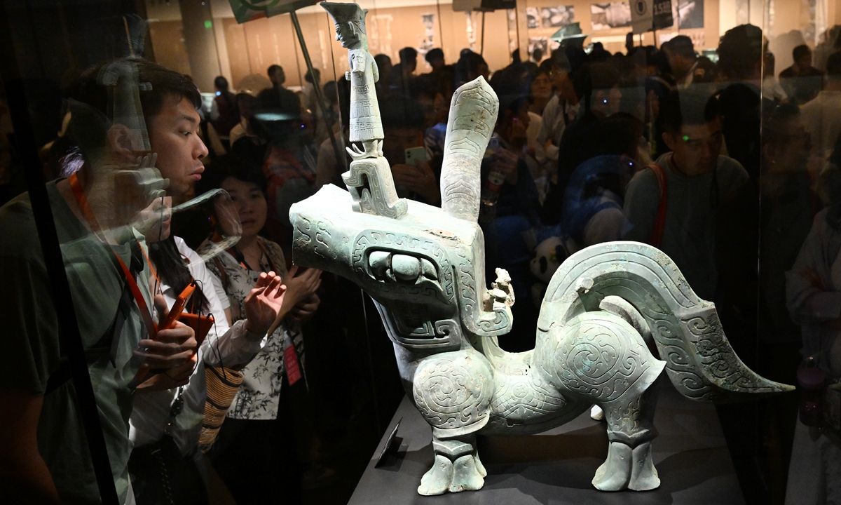 Tourists crowd around a bronze mythical beast on display at the Sanxingdui Museum in Guanghan, Deyang, Southwest China's Sichuan Province on April 18, 2025. The day marks the International Day of Monuments and Sights, or World Heritage Day. Photo: VCG
