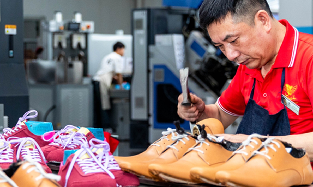 Employees work on a shoe assembly line in a factory in Wenzhou, East China's Zhejiang Province on April 20, 2025. China's GDP grew 5.4 percent year-on-year in the first quarter of 2025, data from the National Bureau of Statistics showed. Photo: VCG