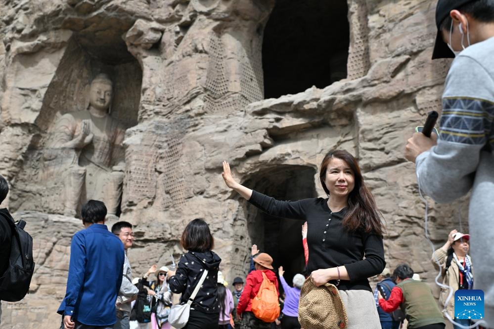 Tourists visit Yungang Grottoes in Datong, north China's Shanxi Province, April 15, 2025. Yungang Grottoes was built during the Northern Wei Dynasty (386-534). It is considered a pinnacle of Chinese Buddhist art and represents the highest level of sculptural artistry in the world during the 5th century. In recent years, Shanxi has made great efforts to protect and study the grottoes. In 2021, the research institute of the Yungang Grottoes was established for the protection, research and management of the Yungang Grottoes. (Photo: Xinhua)