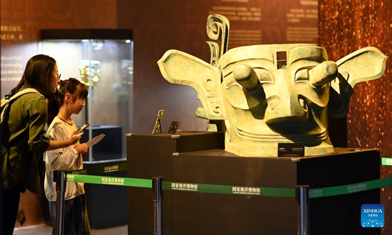 People visit an immersive art exhibition of Sanxingdui at National Maritime Museum of China in north China's Tianjin, April 22, 2025. Through aesthetic design, music, lighting and other digital multimedia means, the recently opened art exhibition provides visitors with an immersive historical space showcasing the art aesthetics, bronze ware culture, sacrificial culture, and spiritual inheritance of the Sanxingdui Ruins. (Photo: Xinhua)