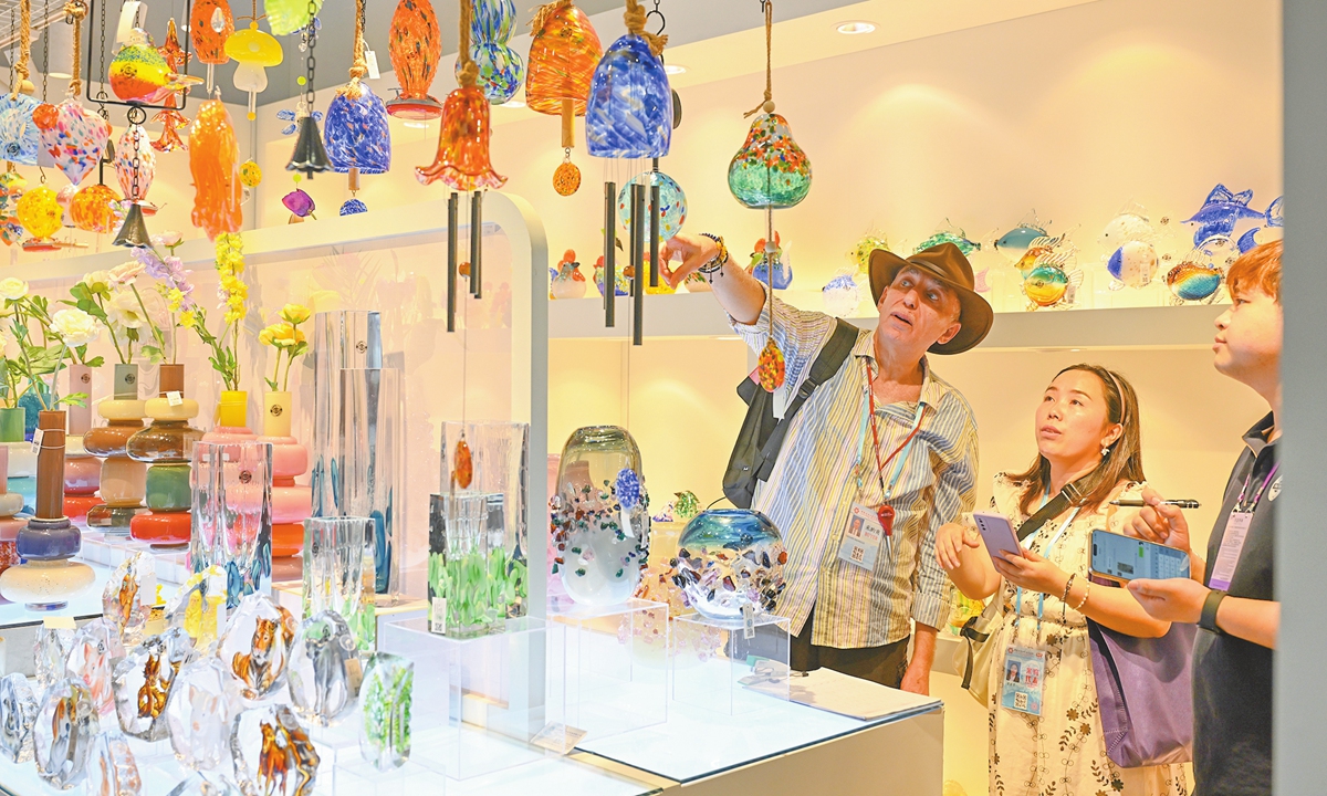 A foreign customer communicates with exhibitors about glassware at the 137th Canton Fair in Guangzhou, South China's Guangdong Province on April 24, 2025. The second phase of the Canton Fair features an exhibition area of 515,000 square meters, with 24,735 booths and 10,313 exhibitors from home and abroad. Photo: VCG