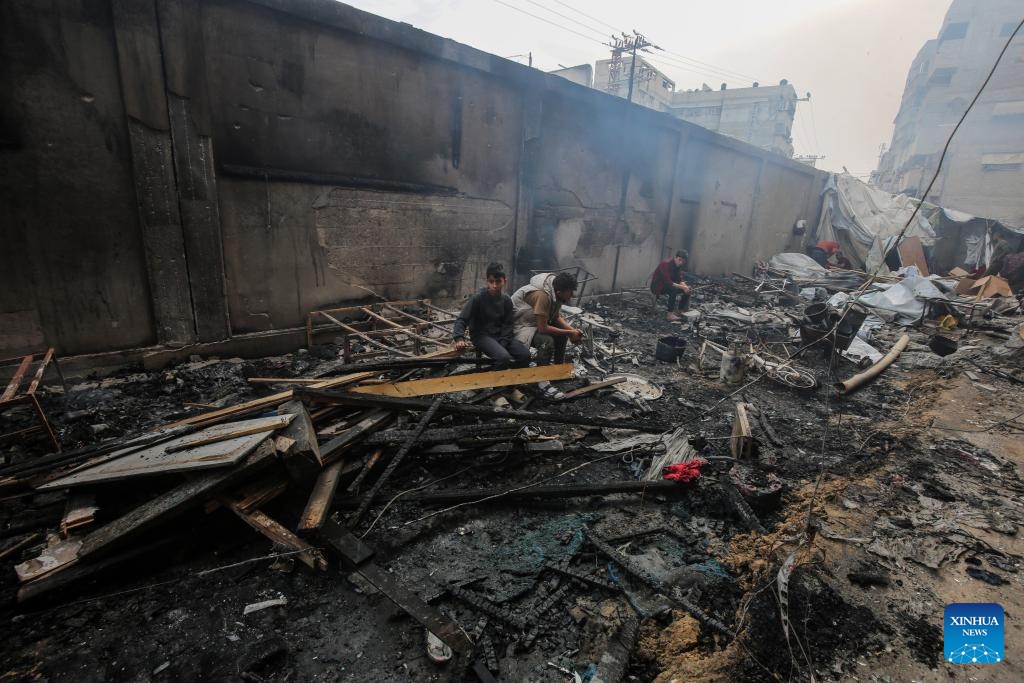 Palestinians are seen at a school after an Israeli airstrike in Gaza City, on April 23, 2025. Israel's Shin Bet domestic security agency and the military said on Wednesday that a deadly overnight airstrike targeting a school sheltering displaced families in northern Gaza was aimed at militants. Gaza's health authorities said the strike killed at least 10 people and caused fires in tents and classrooms at the school. (Photo: Xinhua)