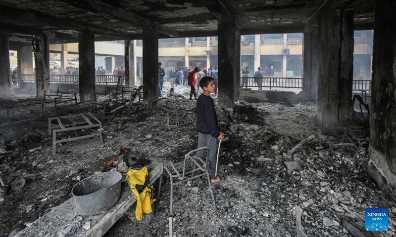 Palestinians are seen at a school after an Israeli airstrike in Gaza City, on April 23, 2025. Israel's Shin Bet domestic security agency and the military said on Wednesday that a deadly overnight airstrike targeting a school sheltering displaced families in northern Gaza was aimed at militants. Gaza's health authorities said the strike killed at least 10 people and caused fires in tents and classrooms at the school. (Photo: Xinhua)