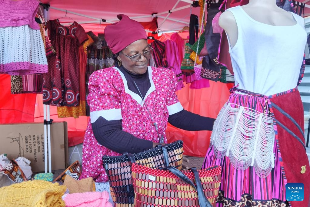A woman showcases artisanal products at the annual /Ae //Gams Arts and Cultural Festival in Windhoek, Namibia, on April 25, 2025. Namibia's capital Windhoek turned into a vibrant spectacle of cultural energy as the annual /Ae //Gams Arts and Cultural Festival kicked off Friday, marking its 18th edition. The two-day event features traditional dances, fashion, cuisine, and artisanal products from local and international vendors. (Photo: Xinhua)