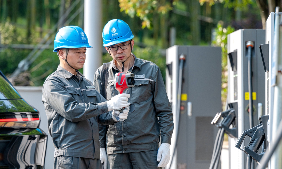 Workers from State Grid conduct a safety inspection of new-energy vehicle charging piles in Changxing county, Huzhou city of East China's Zhejiang Province on April 28, 2025. China aims to make pure electric vehicles the mainstream of new car sales by 2035, according to an official circular released recently. Photo: VCG