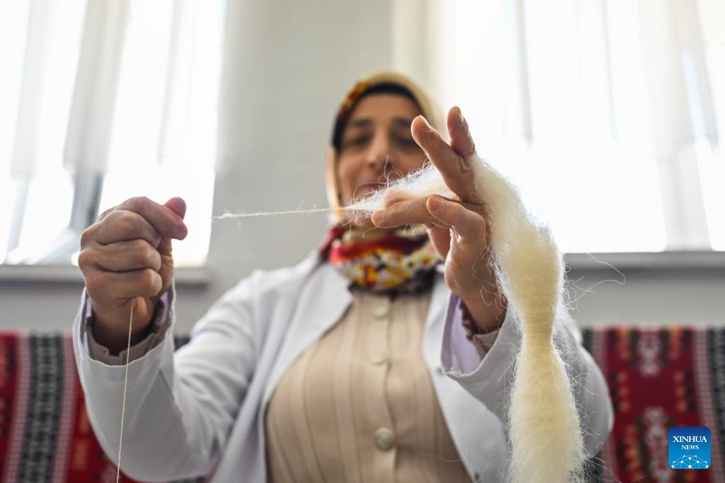 A worker twists wool into thread at the Erzurum Maturation Institute in Erzurum, Türkiye, on April 25, 2025. Erzurum, a province in northeastern Türkiye, has a long-standing tradition of wool weaving. Since the 1850s, Ehram, a finely spun wool fabric, has become a renowned local specialty. The production of Ehram involves multiple intricate processes. Initially utilized for women's garments, it has since been adapted for a variety of accessories, including handbags and belts. (Photo: Xinhua)