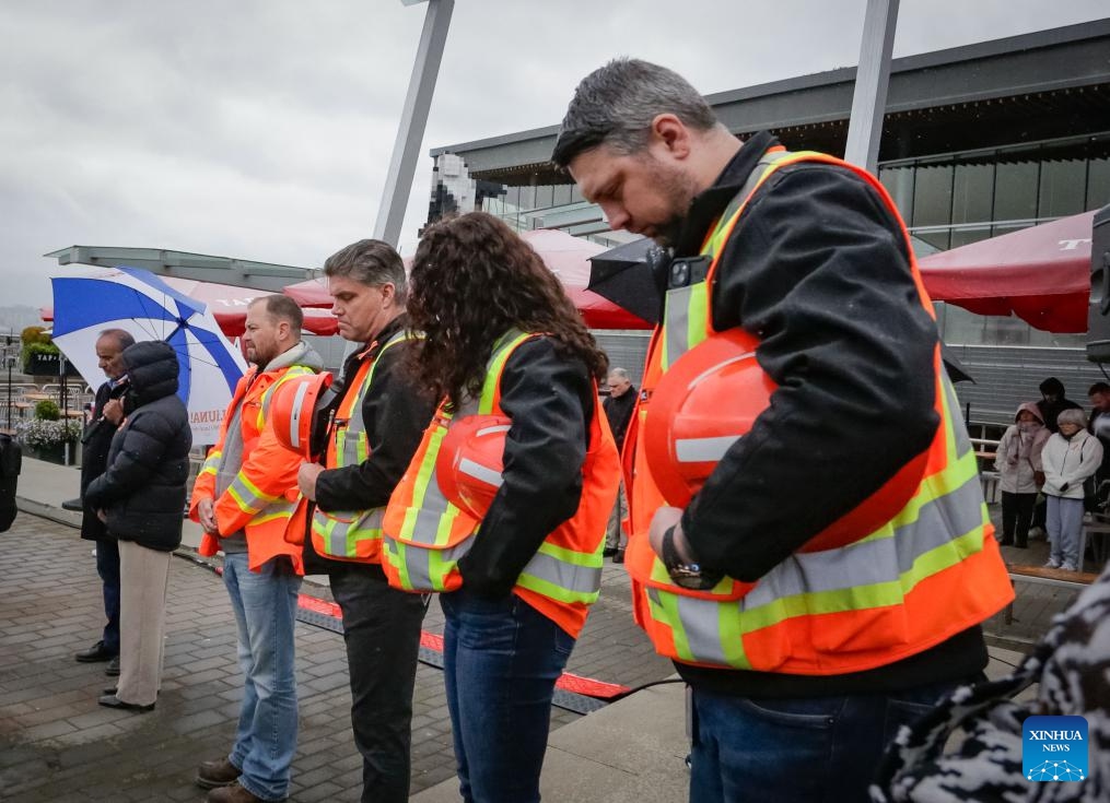 People observe a moment of silence during the National Day of Mourning event in Vancouver, British Columbia, Canada, on April 28, 2025. The National Day of Mourning is observed annually in Canada on April 28 to commemorate people who have lost their lives, suffered injury or illness on the job, or experienced a work-related tragedy, and to raise awareness of health and safety in the workplace. (Photo: Xinhua)