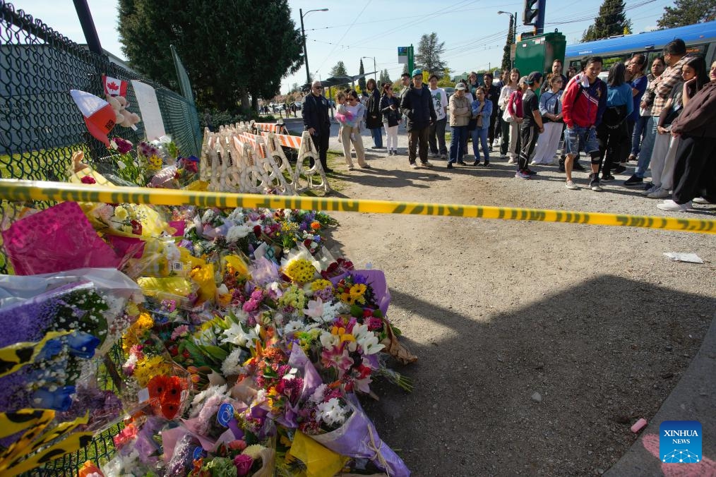 People gather near the site of a car crash in Vancouver, British Columbia, Canada, April 27, 2025. A total of 11 people have been confirmed dead after a driver drove into a crowd at a street festival in Vancouver, Canada, on Saturday evening, said the police on Sunday. (Photo: Xinhua)