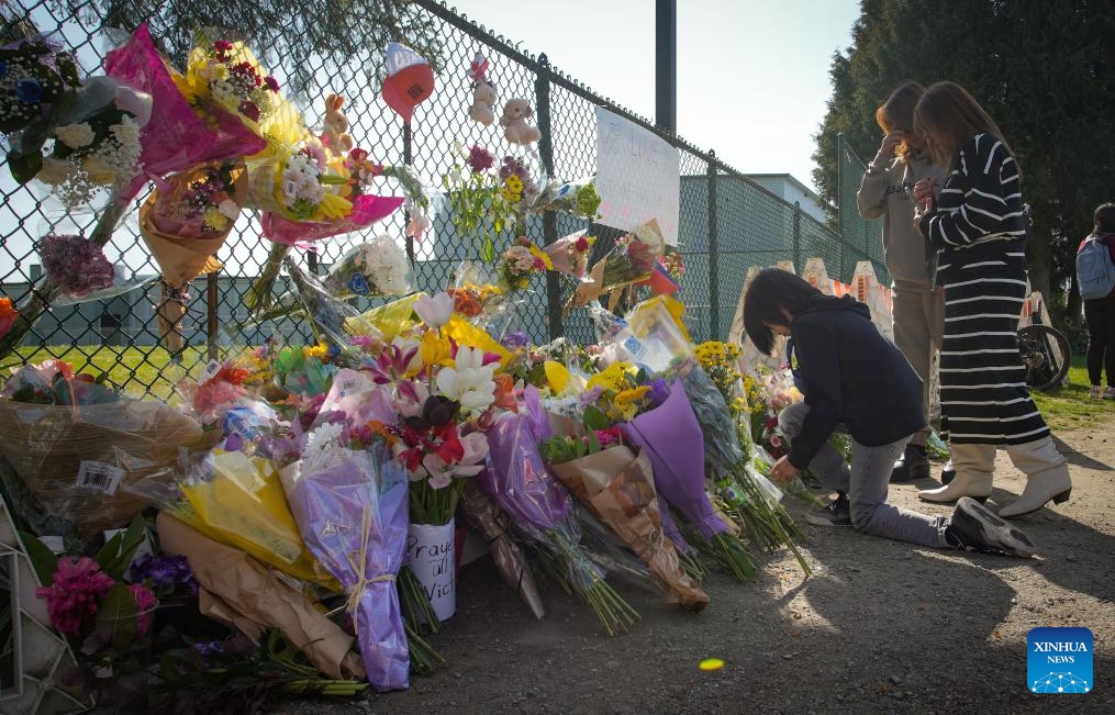 People lay flowers near the site of a car crash in Vancouver, British Columbia, Canada, April 27, 2025. A total of 11 people have been confirmed dead after a driver drove into a crowd at a street festival in Vancouver, Canada, on Saturday evening, said the police on Sunday. (Photo: Xinhua)