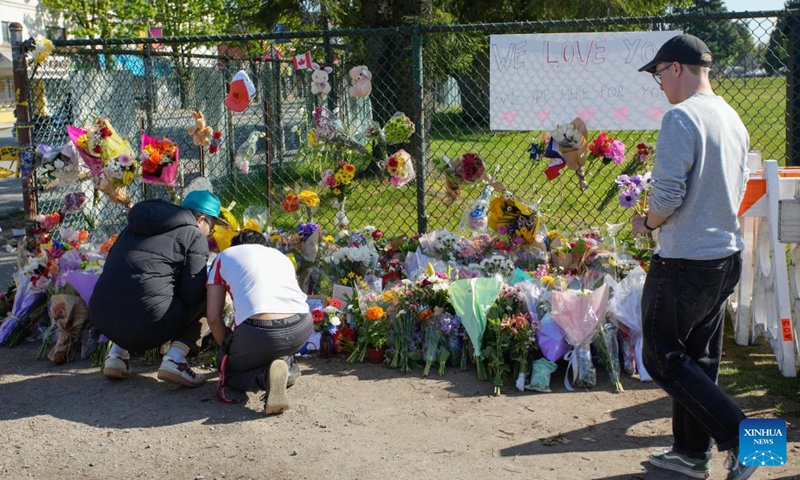 People lay flowers near the site of a car crash in Vancouver, British Columbia, Canada, April 27, 2025. A total of 11 people have been confirmed dead after a driver drove into a crowd at a street festival in Vancouver, Canada, on Saturday evening, said the police on Sunday. (Photo: Xinhua)