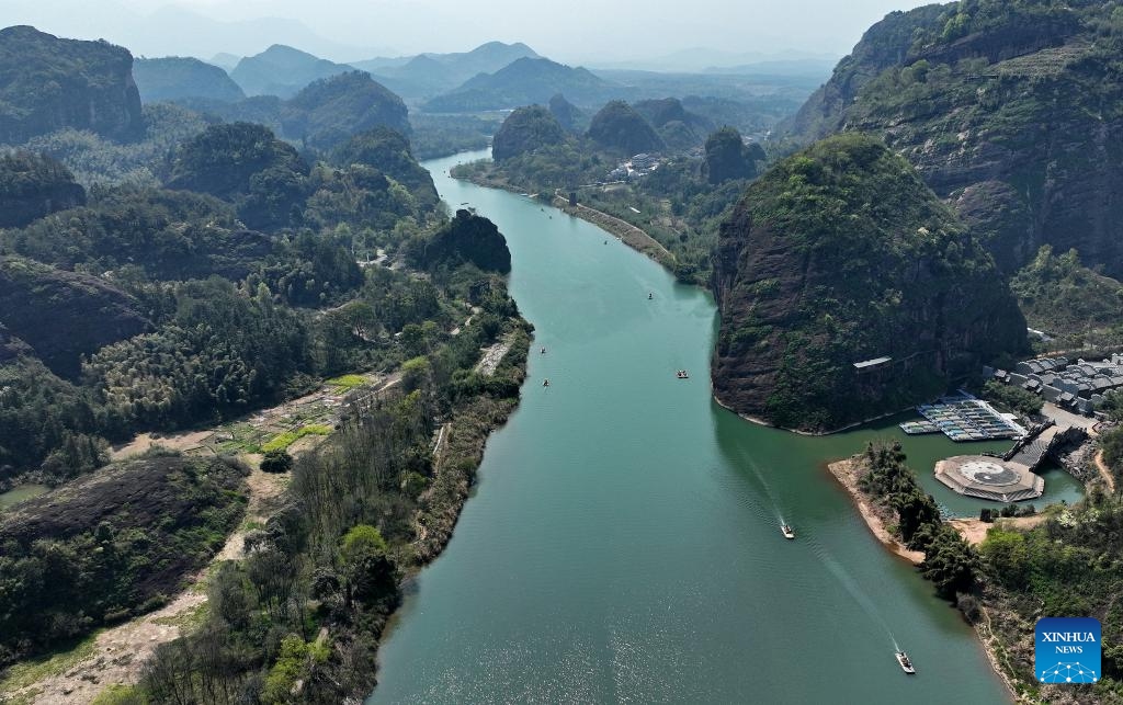 An aerial drone photo taken on March 25, 2025 shows tourists touring the Longhu Mountain scenic area on bamboo rafts in Yingtan, east China's Jiangxi Province. Titled UNESCO Global Geopark, Longhu Mountain of Jiangxi Province is a natural site on World Heritage List and one of the birthplaces of Taoism in China. Taoism, or Daoism, is a 2,000-year-old religion that originated from Laozi's philosophy. Its key doctrines include seeking harmony with the eternal cosmic order known as Dao and cherishing one's life. (Photo: Xinhua)