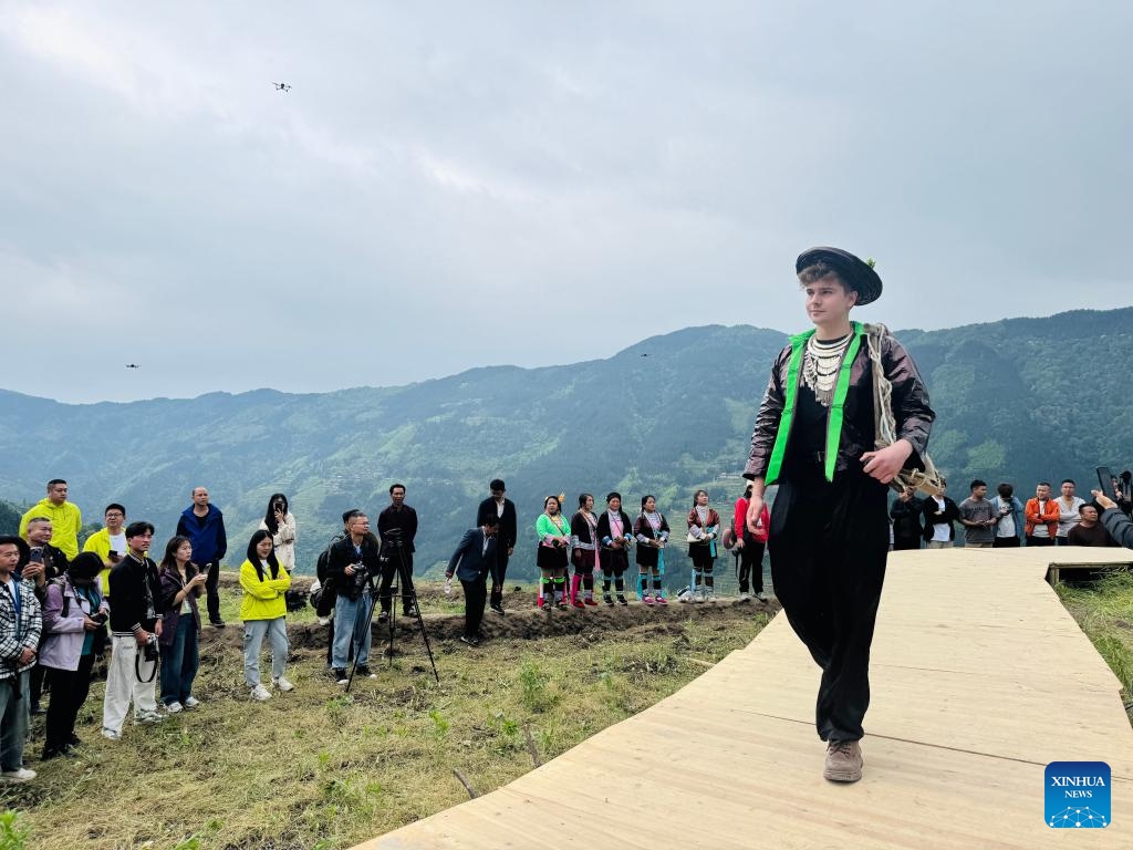 German blogger Robert Adolf, dressed in local ethnic costume, participates in a fashion show in the terraced fields of Jiabang in southwest China's Guizhou Province, April 26, 2025. (Photo: Xinhua)
