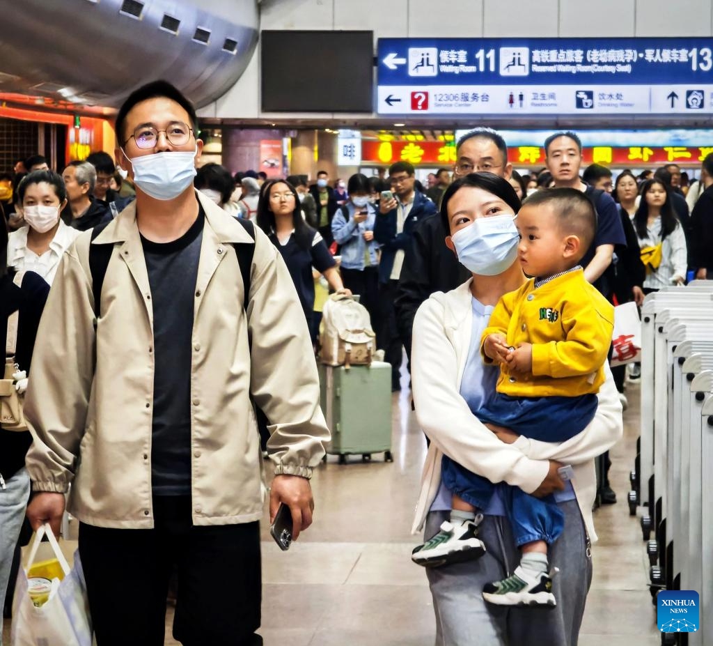 Passengers walk at Beijing West Railway Station in Beijing, capital of China, April 30, 2025. China's railway network is expected to handle approximately 144 million passenger trips during the eight-day May Day holiday travel rush, which kicked off on Tuesday, the national railway operator said. (Xinhua/Xing Guangli)