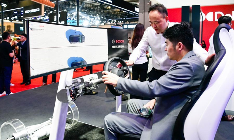 A visitor tries a steering system solution of Bosch Huayu at the 21st Shanghai International Automobile Industry Exhibition in east China's Shanghai, April 25, 2025. (Xinhua/Wang Xiang)