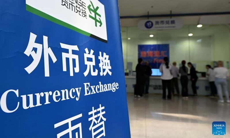 Tourists exchange currency at Tianjin International Cruise Home Port in north China's Tianjin Municipality, May 1, 2025. Tianjin International Cruise Home Port welcomed the simultaneous berthing of three international cruise ships on the first day of May Day holiday, which was the first time since its resumption of operations. According to statistics, on May 1, the number of inbound and outbound passengers reached nearly 15,000, with over 400 travelers applying for visa-free entry with a period of 240 hours. Photo: Xinhua