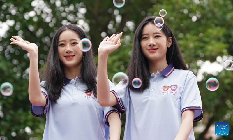 A pair of twins are pictured during the 19th Mojiang international twins festival in Mojiang Hani Autonomous County, southwest China's Yunnan province, May 1, 2025. Over 1,000 multiple births from around the world took part in a parade during the twins festival in Mojiang Hani Autonomous County on Thursday. (Xinhua/Chen Xinbo)
