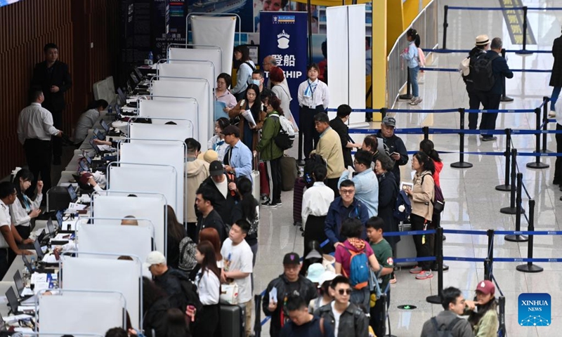 Passengers line up for embarkation procedures at Tianjin International Cruise Home Port in north China's Tianjin Municipality, May 1, 2025. Tianjin International Cruise Home Port welcomed the simultaneous berthing of three international cruise ships on the first day of May Day holiday, which was the first time since its resumption of operations. According to statistics, on May 1, the number of inbound and outbound passengers reached nearly 15,000, with over 400 travelers applying for visa-free entry with a period of 240 hours. Photo: Xinhua