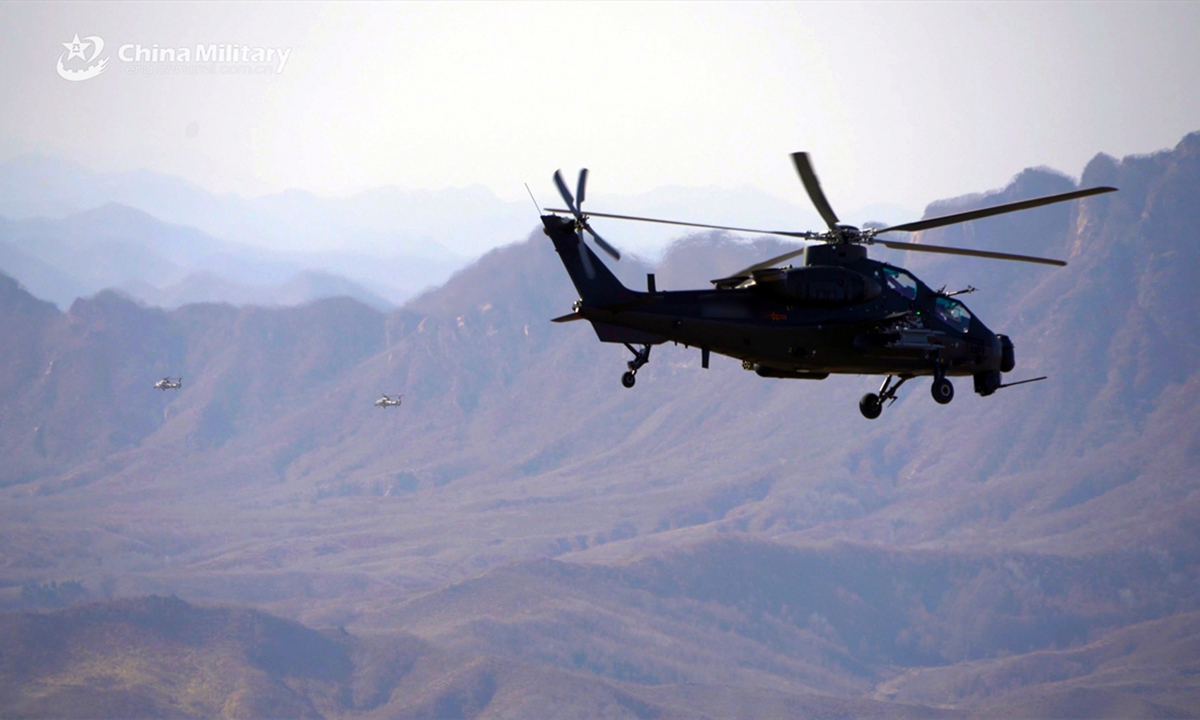 A WZ-10 attack helicopter attached to an army aviation brigade under the Chinese PLA 79th Group Army flies over the mountainous area to a designated airspace during a flight training exercise. (eng.chinamil.com.cn/Photo by Qi Dong and Wang Lijun)