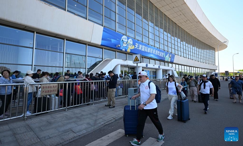 Tourists line up at Tianjin International Cruise Home Port in north China's Tianjin Municipality, May 1, 2025. Tianjin International Cruise Home Port welcomed the simultaneous berthing of three international cruise ships on the first day of May Day holiday, which was the first time since its resumption of operations. According to statistics, on May 1, the number of inbound and outbound passengers reached nearly 15,000, with over 400 travelers applying for visa-free entry with a period of 240 hours. Photo: Xinhua