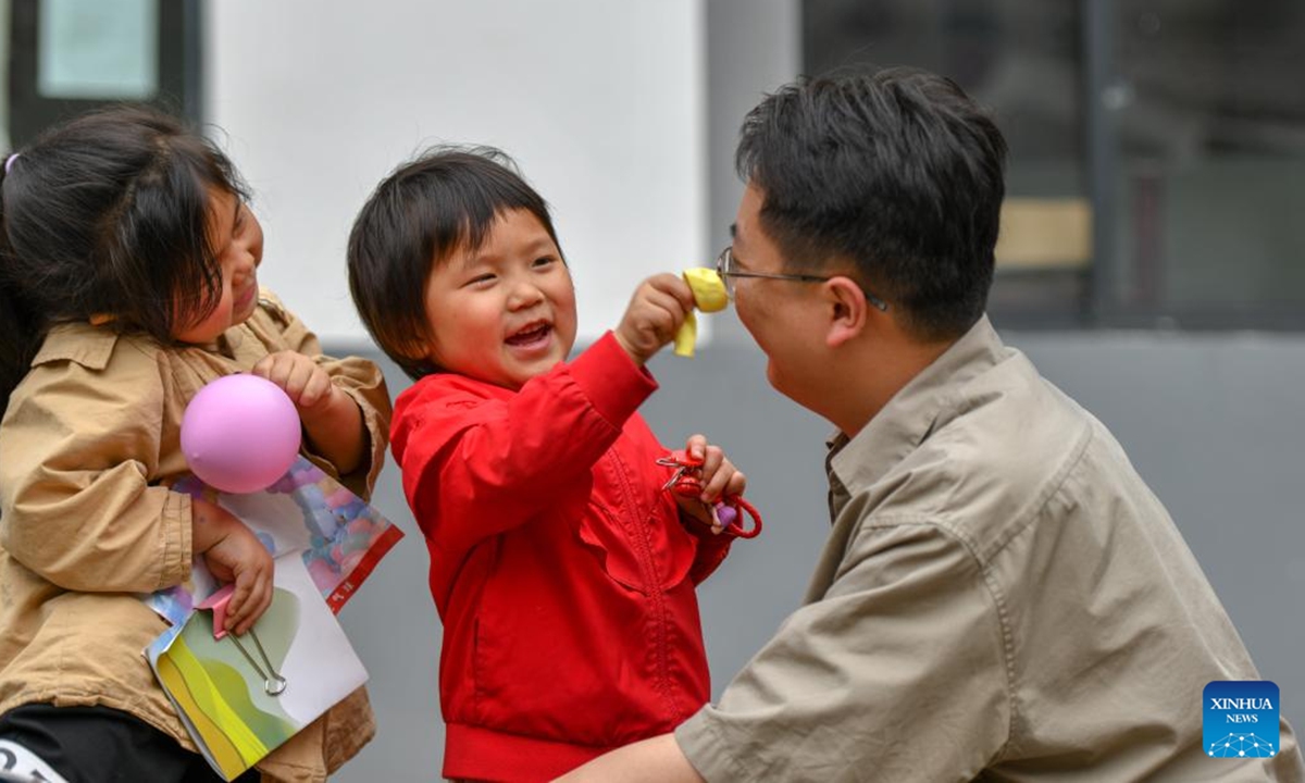 Li Runnan plays with children in Wangu Village of Yanjin County, Zhaotong City, southwest China's Yunnan Province, April 29, 2025. Li Runnan, born in 1996, graduated from Peking University in 2023 and began working as a village cadre in Wangu Village of Yanjin County, Yunnan Province the following year.

