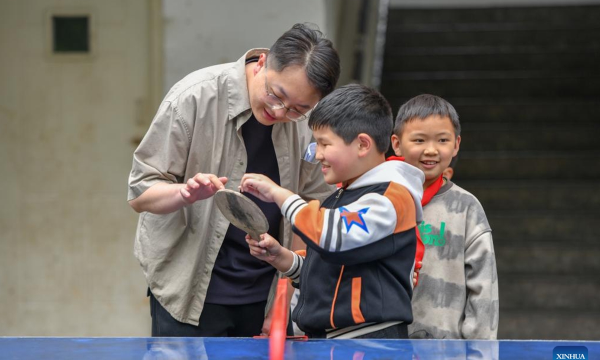 Li Runnan plays with children at a primary school in Wangu Village of Yanjin County, Zhaotong City, southwest China's Yunnan Province, April 29, 2025. Li Runnan, born in 1996, graduated from Peking University in 2023 and began working as a village cadre in Wangu Village of Yanjin County, Yunnan Province the following year.


