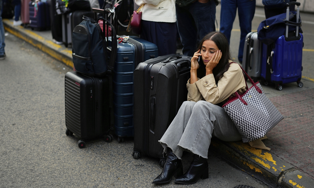 Travelers wait for news about their delayed trains at the Madrid train station, Spain, on May 5, 2025. Spain's transport minister has said the country's rail network suffered