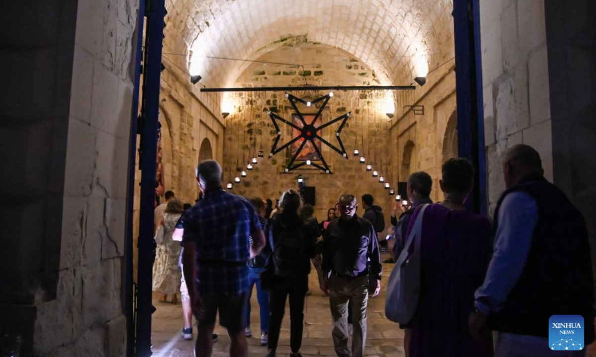 People visit a museum illuminated with light of candles in Birgu, Malta, on May 10, 2025. Heritage Malta, in collaboration with the Birgu Local Council, on Saturday hosted the Museums by Candlelight event. (Photo by Jonathan Borg/Xinhua)