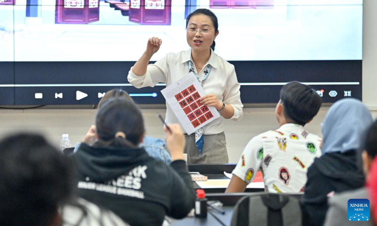 A teacher instructs Chinese calligraphy to students from University of Malaysia Sarawak (UNIMAS) at Vocational and Technical College of Inner Mongolia Agricultural University in Baotou, north China's Inner Mongolia Autonomous Region, May 9, 2025. A total of 21 UNIMAS students on Friday attended here hands-on studio workshops featuring traditional Chinese culture and technical training. (Xinhua/Ma Jinrui)